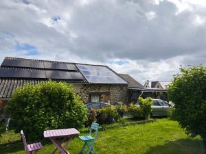 a house with a lot of solar panels on the roof at Chambres Les Salles in Beauvoir