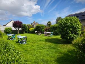 a group of tables and chairs in a yard at Chambres Les Salles in Beauvoir