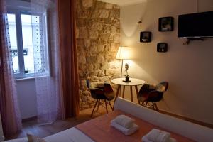a bedroom with a bed and a table with chairs at Split Old Town Suites in Split