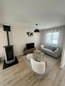 a living room with a couch and a fireplace at Douceur d'Eden in Camaret-sur-Mer