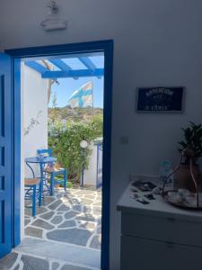 a kitchen with a door open to a patio with a table at Pelagos Studios in Parikia