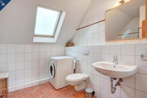 La salle de bains est pourvue de toilettes et d'un lavabo. dans l'établissement Villen am See - 4-Raum Häuser DHH See- Idyll 2, à Korswandt