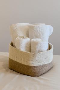 a stack of toilet paper in a basket at Barcelona Amelie Apartment in Hospitalet de Llobregat