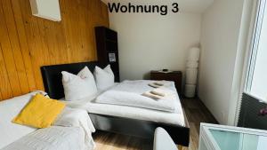 a bedroom with a bed with white sheets and pillows at Ferienwohnung Felix in Templin