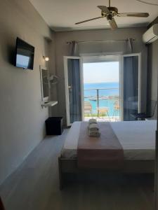 a bedroom with a bed with a view of the ocean at OLYMPIADA View 1 in Pythagoreio