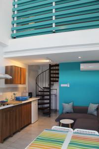 a kitchen and a living room with a couch at Rainbow Apartments in Ayia Napa