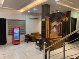 a lobby with a coca cola sign and chairs at Hotel SB Residency in Amritsar