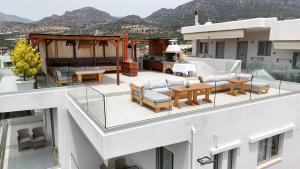 a balcony with a table and chairs on a building at Asterisuites in Makry Gialos