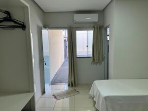 a bedroom with a bed and a view of the ocean at Pousada Xero in Capitólio