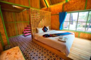 Ένα ή περισσότερα κρεβάτια σε δωμάτιο στο Rosie Garden Măng Đen