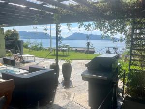 an outdoor patio with a view of the water at Villa by the sea, close to the city, with panoramic views in Bergen