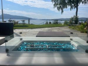 a swimming pool with blue glass rocks in it at Villa med panoramautsikt, stor uteplass og 100 m fra badestrand in Bergen