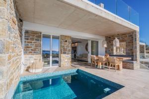 a house with a swimming pool and a patio at Gialova Hills Luxury Villas with Private Pool in Gialova