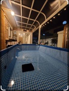 a swimming pool with blue tiles on the floor at Hello minbak in Boseong