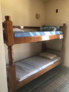a couple of bunk beds in a room at Felicidade in front sea in Saquarema