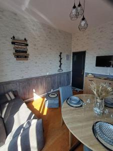 a living room with a table and a couch at Le studio 2 F in Ault +14 photos