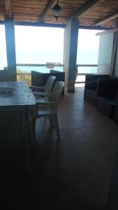 a room with chairs and a table with a view at Relax sul mare di Sicilia in Gela