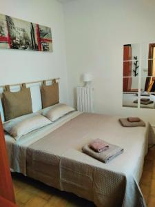 a bedroom with a bed with two towels on it at Michelle Apartment in Bari