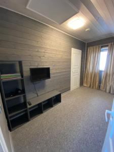 a living room with a flat screen tv on a wall at Edelweiss Holiday House - Šventoji in Palanga