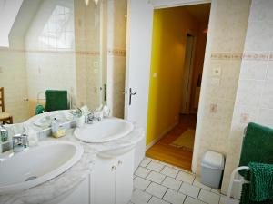 a bathroom with two sinks and a shower at Chambres Les Salles in Beauvoir