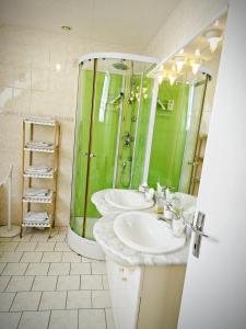 a bathroom with two sinks and a shower at Chambres Les Salles in Beauvoir