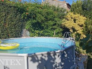 a hot tub with a yellow bowl on top of it at Les chambres de Cherveux in Cherveux