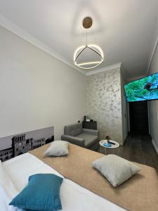 a bedroom with a bed and a couch and a table at Centroom boutique hotel in Yerevan