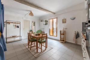 una cucina e una sala da pranzo con tavolo e sedie di Le Pastel Riverside Centre historique proche des plages ad Agde