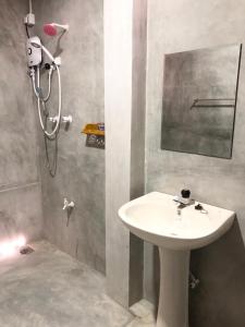 a bathroom with a white sink and a shower at Bimsara Mount Villa in Weligama