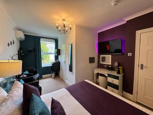 a bedroom with a large bed and purple walls at The 25 Boutique B&B - Adults Only in Torquay
