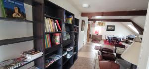a room with book shelves filled with books at F3 tout confort spacieux in Mauves-sur-Huisne