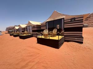 a row of luxury tents in the desert at Desert Bedouin adventure in Wadi Rum