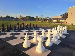 a large chessboard with a lot of white chess pieces at Olympia Suites in Pyrgos