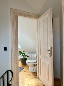 an open door to a bathroom with a toilet at Winter Heaven in Strzelce +13 photos