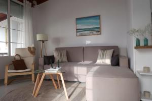 a living room with a couch and a table at Onar House I in Achladies +20 photos
