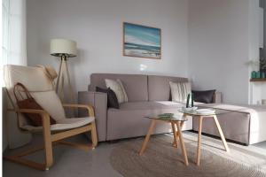 a living room with a couch and a chair and a table at Onar House I in Achladies