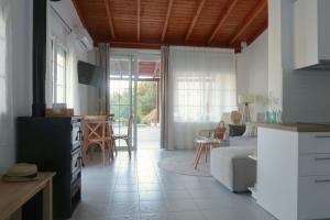 a kitchen and living room with a couch and a table at Onar House I in Achladies