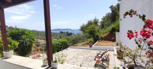 a balcony with benches and a view of the ocean at Onar House I in Achladies