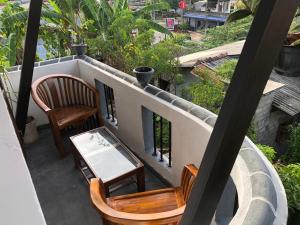 a balcony with two chairs and a table at Bimsara Mount Villa in Weligama