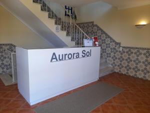 a white wall in a room with a staircase at Aurora Sol in Luz