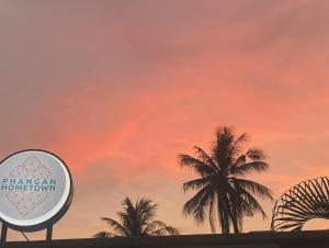 a group of palm trees against a sunset at Phangan Hometown Resort - Adults Only in Ban Tai +27 photos
