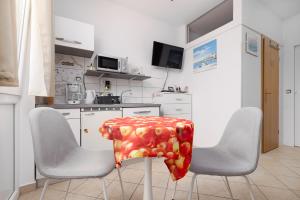 a kitchen with a table with apples on it at Studio with terrace & sea view in Vrsar