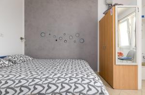 a bedroom with a bed and a wall with a mirror at Studio with terrace & sea view in Vrsar