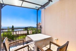 a balcony with a table and chairs and a view at Studio with terrace & sea view in Vrsar