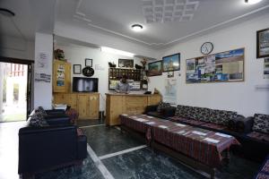 una sala de estar con sofás y una persona en el fondo en Hotel Jan Palace, en Leh
