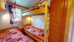 a bedroom with two bunk beds and a window at La Paranthese Marine in Brem-sur-Mer +40 photos