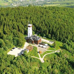 an aerial view of a lighthouse in the middle of a forest at Berghotel Pöhlberg in Annaberg-Buchholz