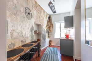 a kitchen with a long wooden table in a room at Menton Old Town in Menton
