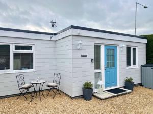 a small white house with a table and chairs at Bow Cottage in Bridport