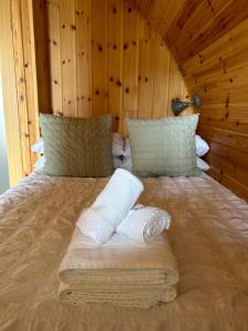 a bed with two towels on it in a room at Allt Yelkie Pod Coig, Earlish in Earlish